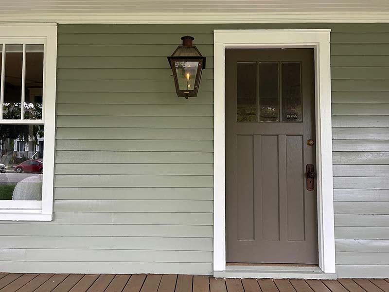 Close up of front door with new siding installation