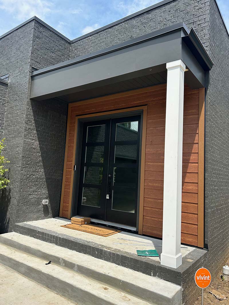 Modern door with wood siding accents on the exterior