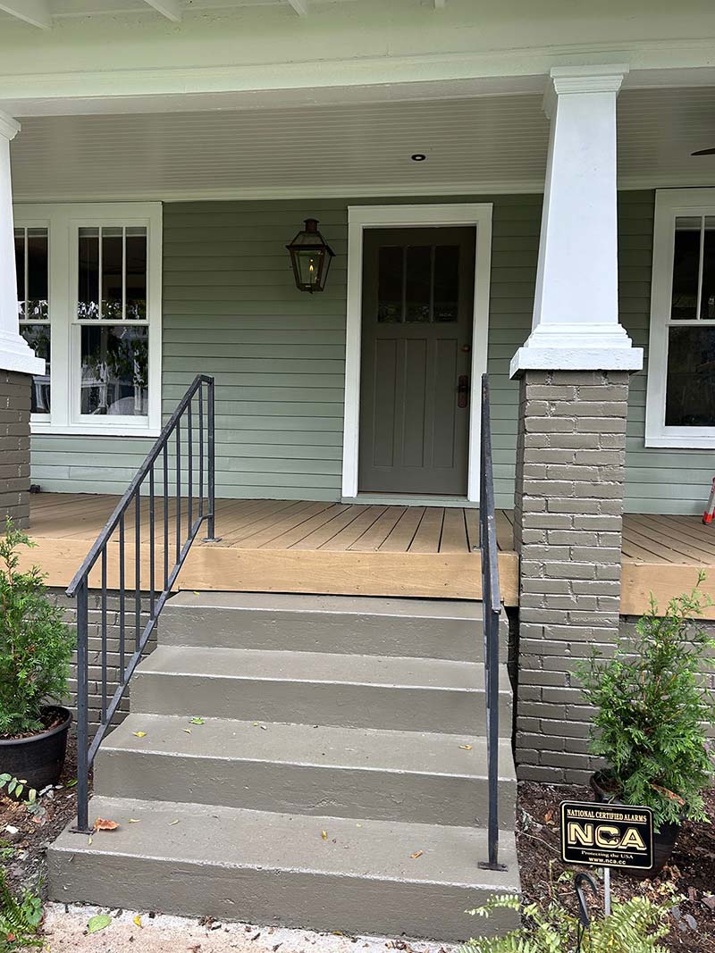 Front exterior of a home with green siding installed
