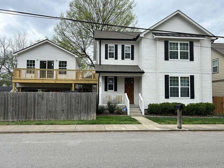 Two story white home with new siding exterior