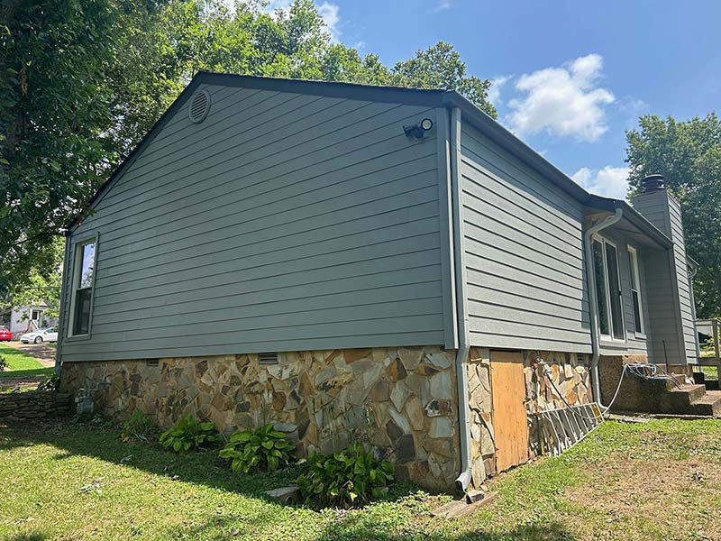The back of a house showcasing new siding installation