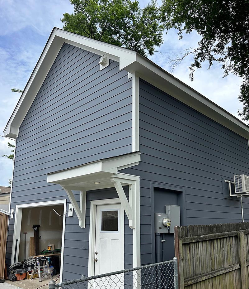 Blue two story garage siding installation