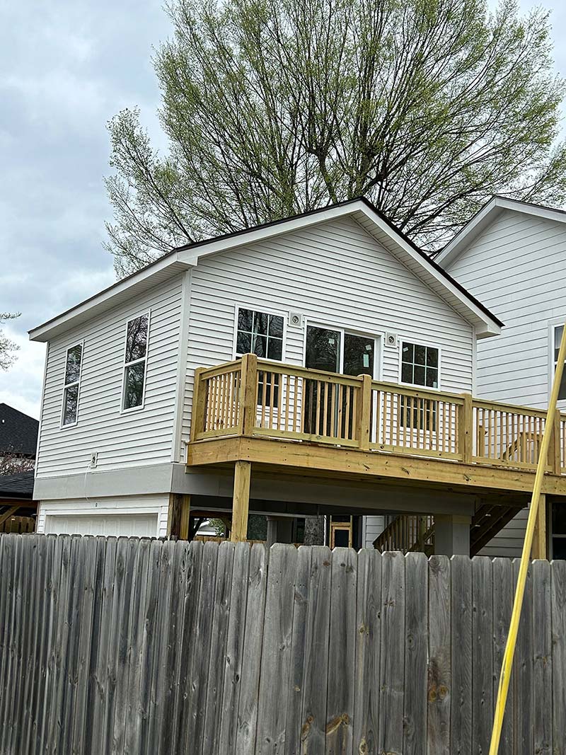 Two story home with a new deck and new siding