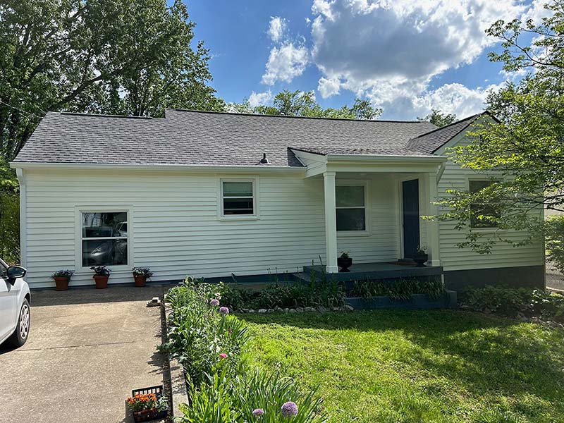 Front side of a white home with siding replacement