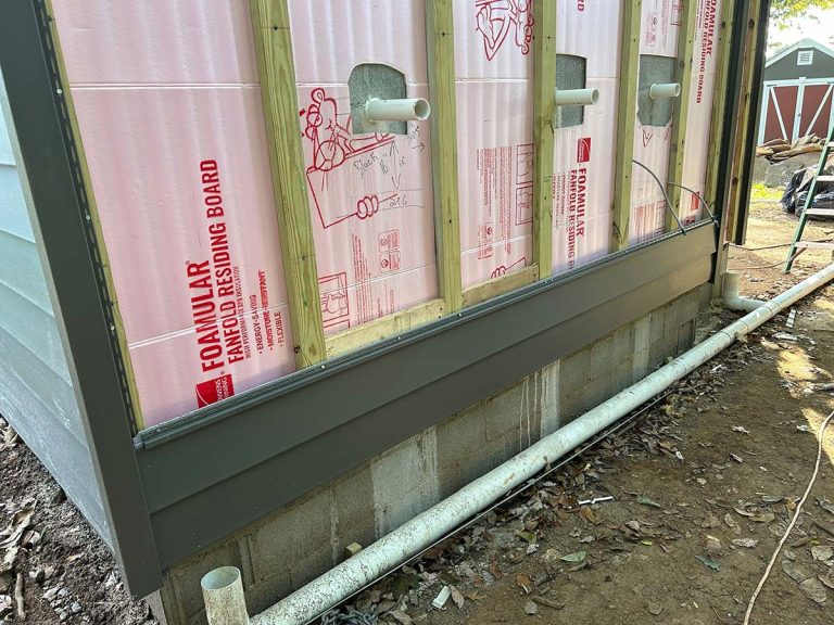 Side of a house in need of siding install