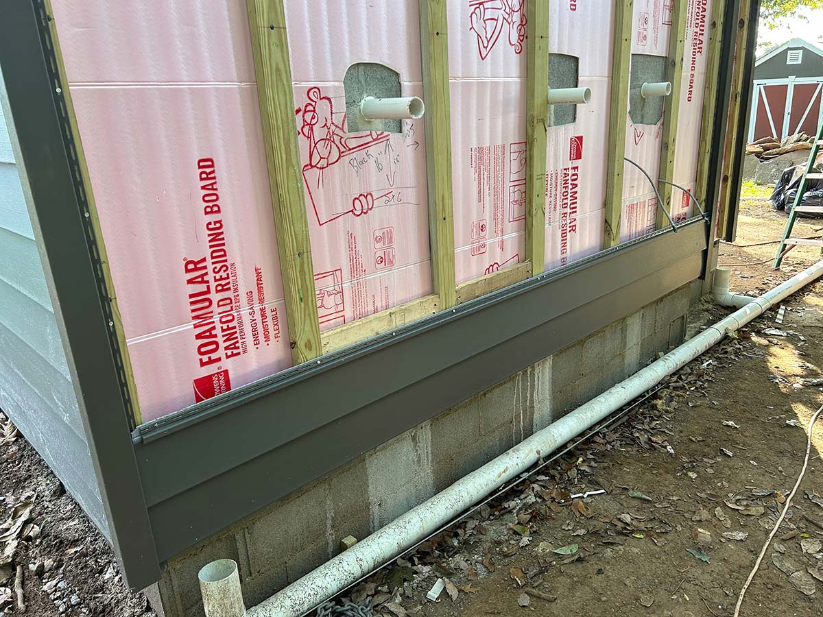 Side of a house in need of siding install