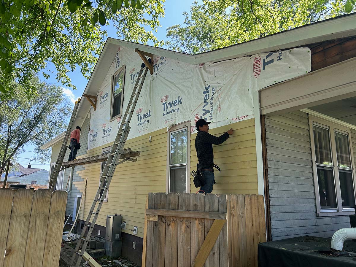 The Illinois Project - Located in The Nations Neighborhood in North West Nashville - Before image showing the crew working on putting up the new siding