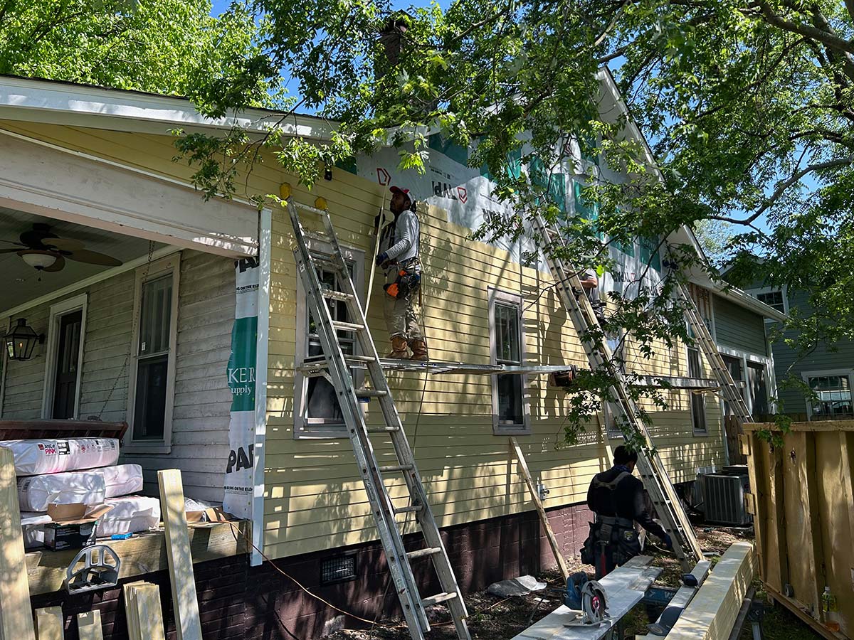 The Illinois Project - Located in The Nations Neighborhood in North West Nashville - Before image showing the crew working on putting up the new siding on the side of the home