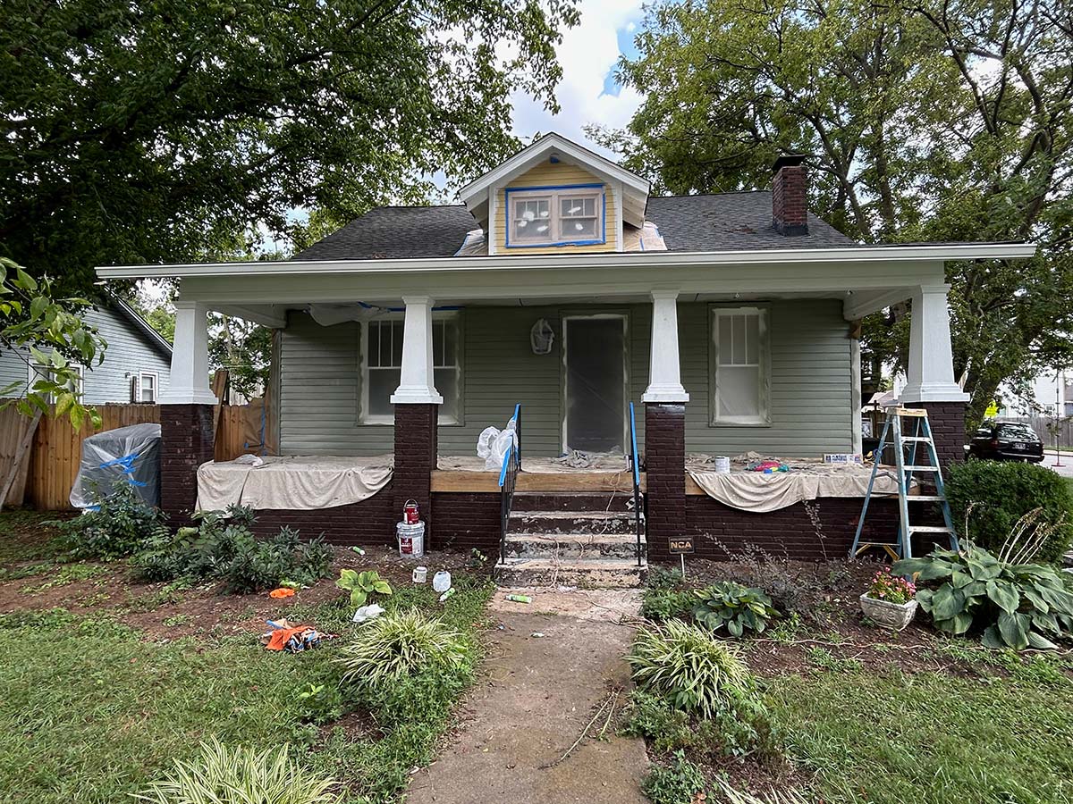 The Illinois Project After - Located in The Nations Neighborhood in North West Nashville - After image showing the crew working on painting the front of the house