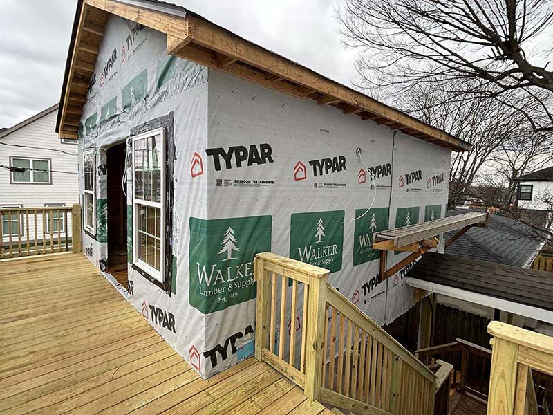 Front porch image with tyvek wrapped sheeting before vinyl siding install